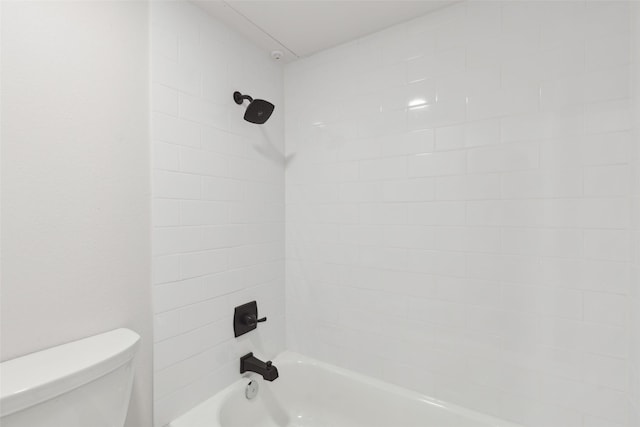 bathroom featuring shower / bathing tub combination and toilet