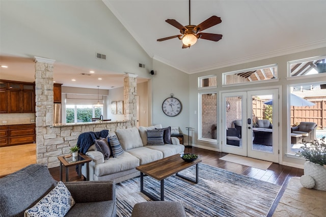 living room with crown molding, decorative columns, visible vents, and dark wood-style flooring