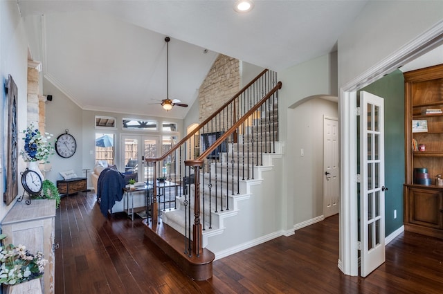 staircase featuring baseboards, hardwood / wood-style floors, french doors, arched walkways, and high vaulted ceiling