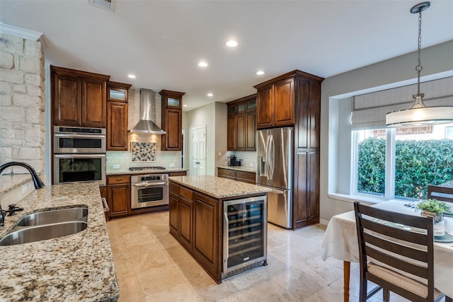 kitchen featuring backsplash, wine cooler, appliances with stainless steel finishes, wall chimney exhaust hood, and a sink