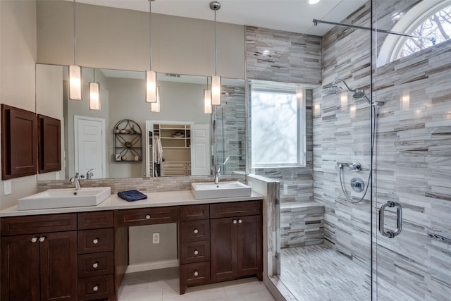 full bathroom with a sink, a stall shower, and a wealth of natural light