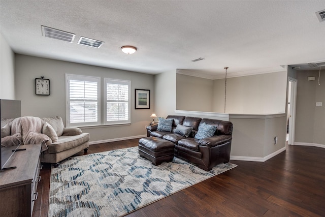 living room featuring visible vents, attic access, and dark wood finished floors