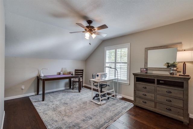 office space featuring baseboards, lofted ceiling, a ceiling fan, and dark wood-style flooring