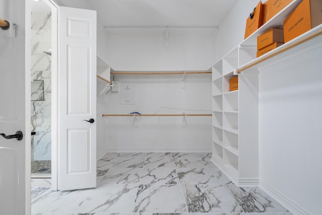 spacious closet featuring marble finish floor