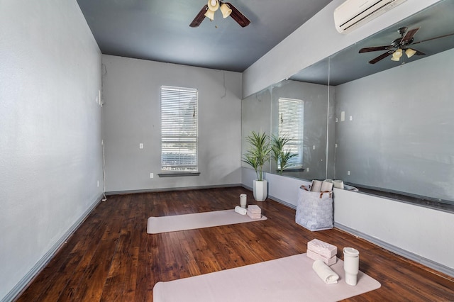 interior space with a wealth of natural light, a wall mounted air conditioner, ceiling fan, and wood finished floors