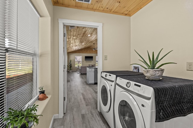 laundry area featuring light wood finished floors, visible vents, wood ceiling, laundry area, and independent washer and dryer