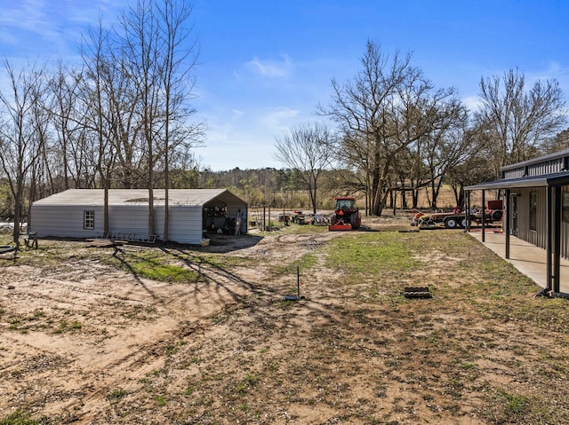 view of yard with a carport and dirt driveway