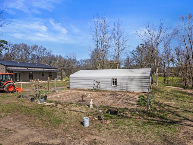 view of yard with a garden and an outdoor structure