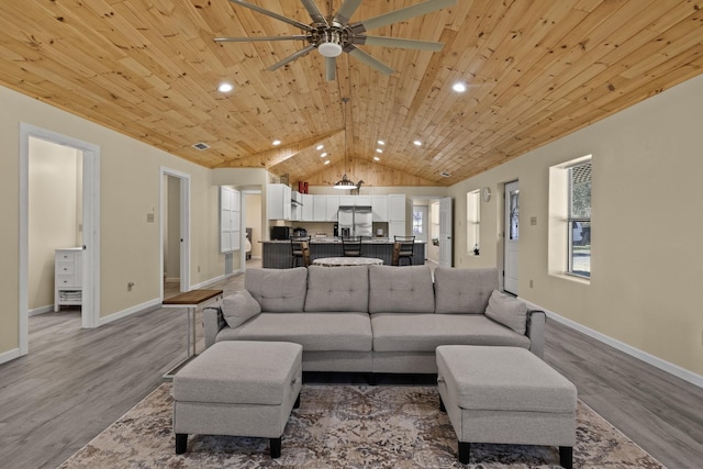 living area featuring baseboards, wood ceiling, lofted ceiling, and wood finished floors