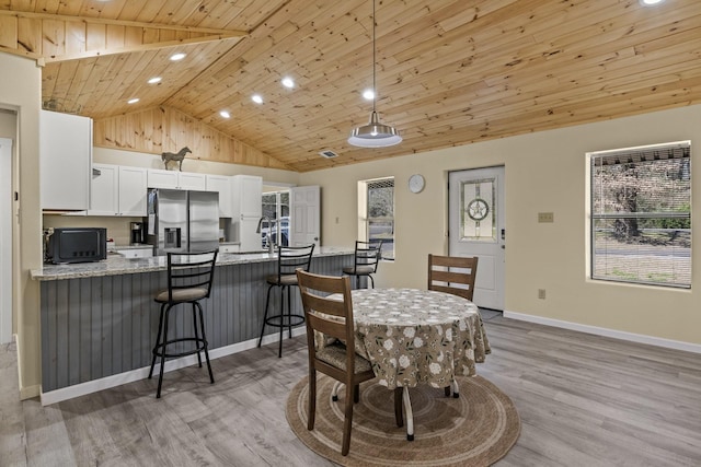 dining space featuring baseboards, high vaulted ceiling, light wood-style flooring, recessed lighting, and wooden ceiling