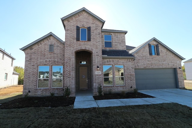 view of front facade featuring brick siding, driveway, and roof with shingles