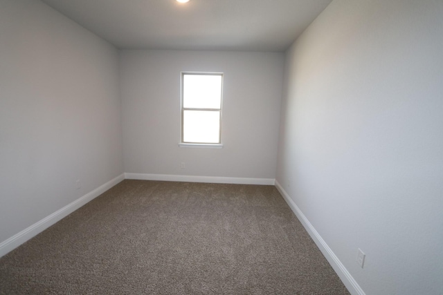 empty room with carpet flooring and baseboards