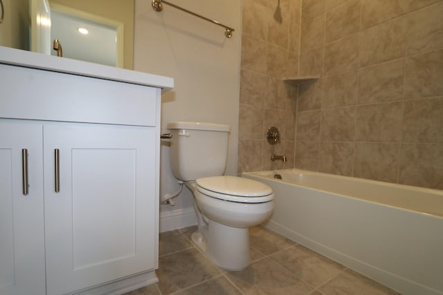 full bathroom featuring tile patterned floors, toilet, shower / bath combination, baseboards, and vanity