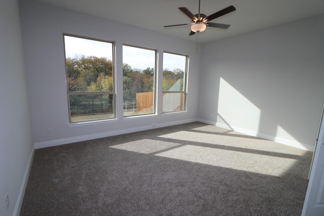 unfurnished room with a ceiling fan, baseboards, and carpet floors