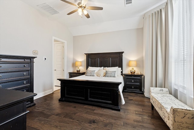 bedroom with dark wood-type flooring, baseboards, visible vents, and vaulted ceiling