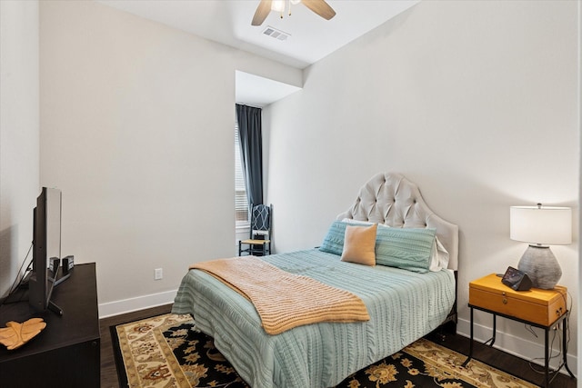 bedroom with visible vents, ceiling fan, baseboards, and wood finished floors