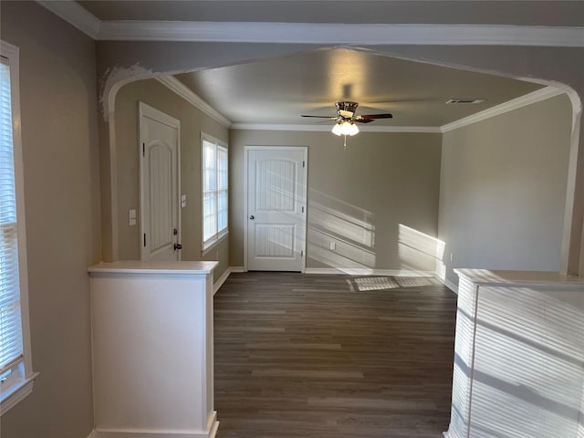 entryway with dark wood finished floors, arched walkways, visible vents, and ornamental molding