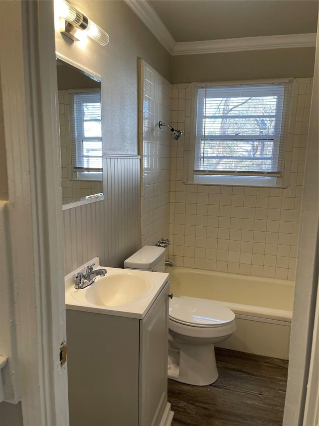 full bath with vanity, wood finished floors, tub / shower combination, crown molding, and toilet