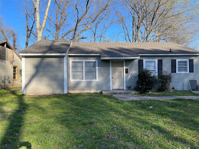 ranch-style house with a front yard and a shingled roof