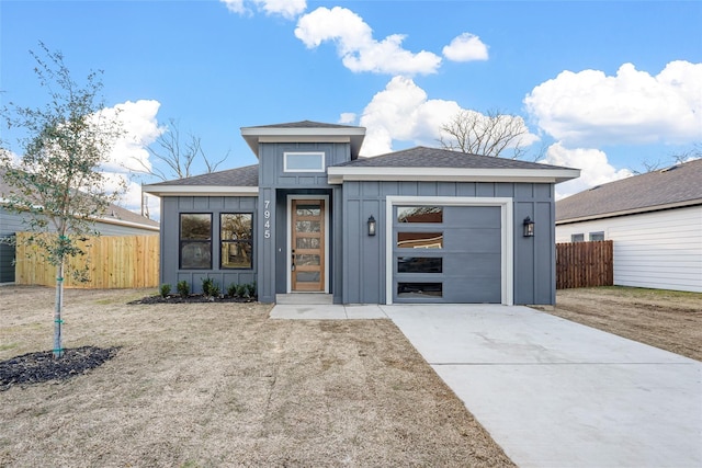 view of front facade featuring board and batten siding, driveway, a garage, and fence