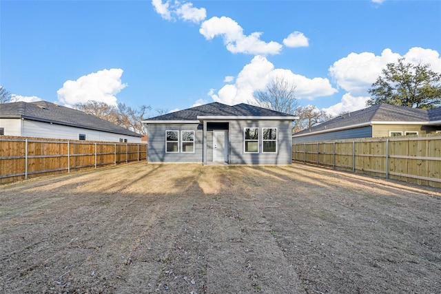 back of property with a fenced backyard