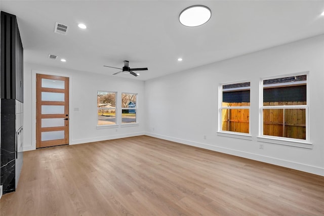 spare room with light wood finished floors, visible vents, baseboards, recessed lighting, and a ceiling fan