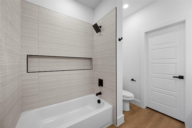 full bathroom with bathtub / shower combination, toilet, wood finished floors, and baseboards