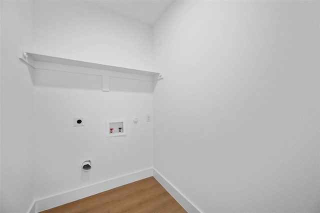 laundry room featuring hookup for an electric dryer, laundry area, light wood-style flooring, washer hookup, and hookup for a gas dryer