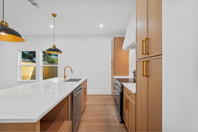 kitchen with visible vents, custom range hood, appliances with stainless steel finishes, light wood-style floors, and a sink