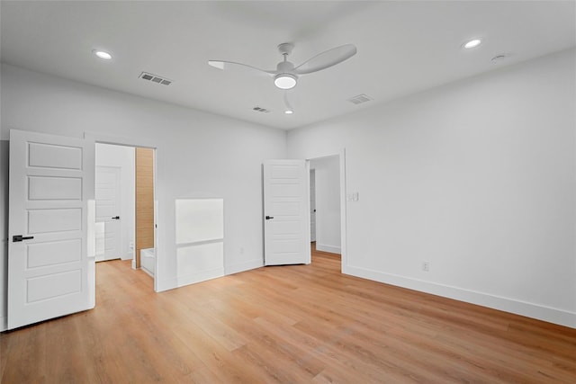 unfurnished bedroom featuring visible vents, light wood-type flooring, and baseboards