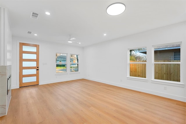 unfurnished room with light wood-style flooring, plenty of natural light, recessed lighting, and visible vents