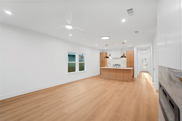 unfurnished living room featuring visible vents, recessed lighting, light wood-type flooring, and a ceiling fan