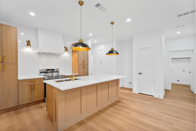 kitchen featuring visible vents, light countertops, recessed lighting, light wood-style floors, and a sink