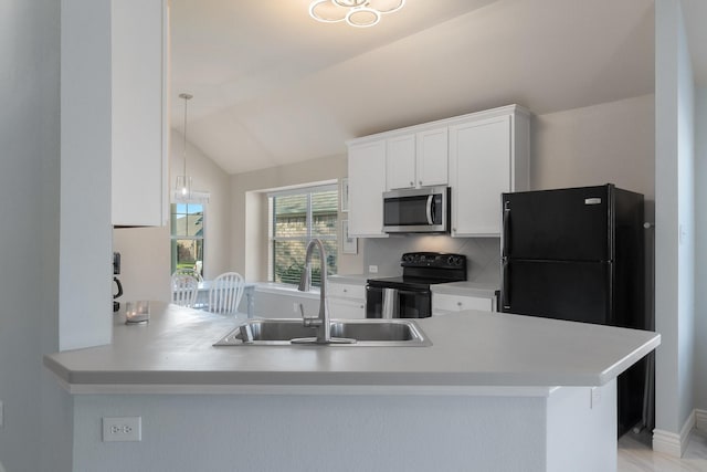 kitchen with lofted ceiling, a sink, black appliances, light countertops, and white cabinetry