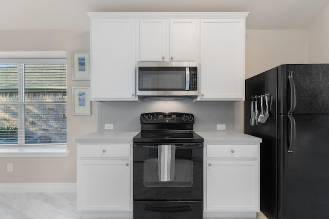 kitchen with plenty of natural light, black appliances, and light countertops