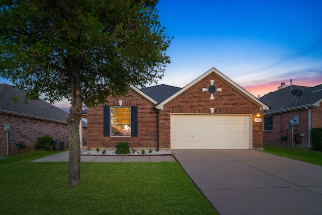 traditional-style home featuring driveway, a front yard, a garage, central air condition unit, and brick siding