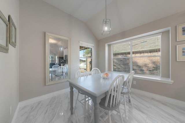 dining room featuring marble finish floor, baseboards, and vaulted ceiling