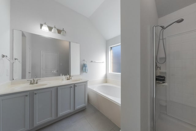 full bath featuring tile patterned floors, a sink, a shower stall, lofted ceiling, and a bath