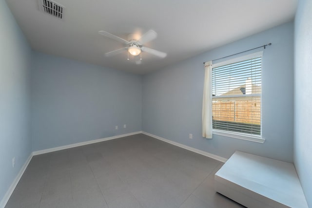 empty room featuring visible vents, baseboards, and a ceiling fan