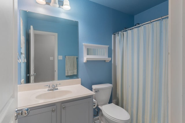 bathroom featuring vanity, a shower with shower curtain, and toilet