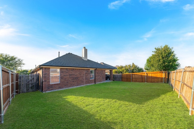 view of yard with a fenced backyard