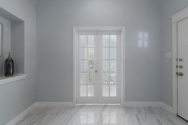 entryway featuring baseboards, french doors, and marble finish floor
