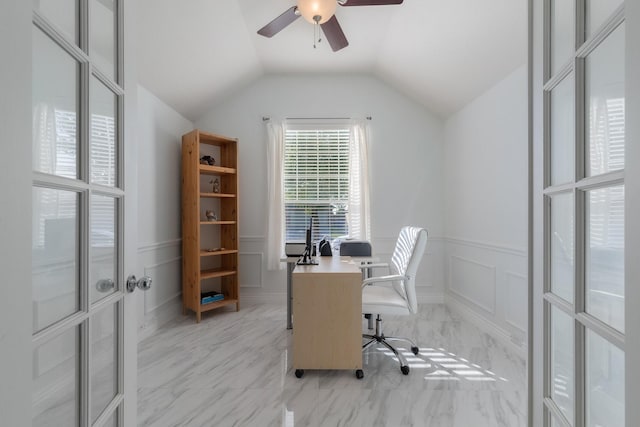 office featuring a ceiling fan, a wainscoted wall, lofted ceiling, and a decorative wall