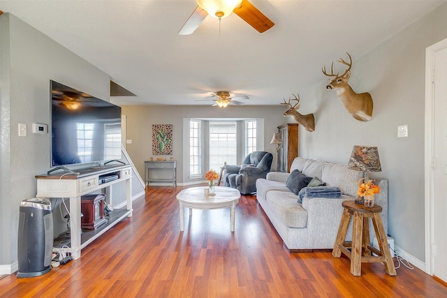 living area with wood finished floors, baseboards, and a healthy amount of sunlight