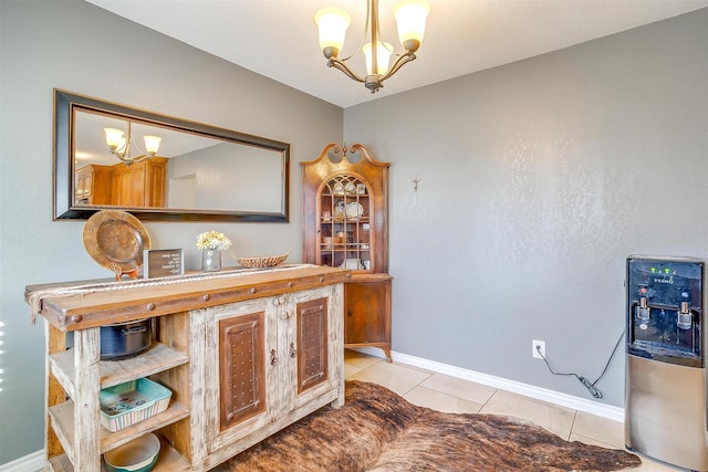 interior space with light tile patterned floors, baseboards, an inviting chandelier, and hanging light fixtures