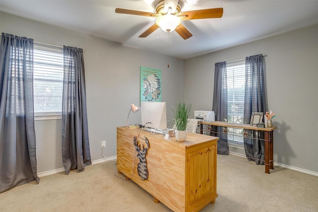 office area with light colored carpet, baseboards, and a healthy amount of sunlight