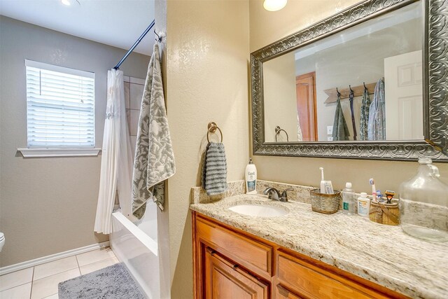 bathroom featuring shower / bath combo with shower curtain, toilet, tile patterned flooring, baseboards, and vanity