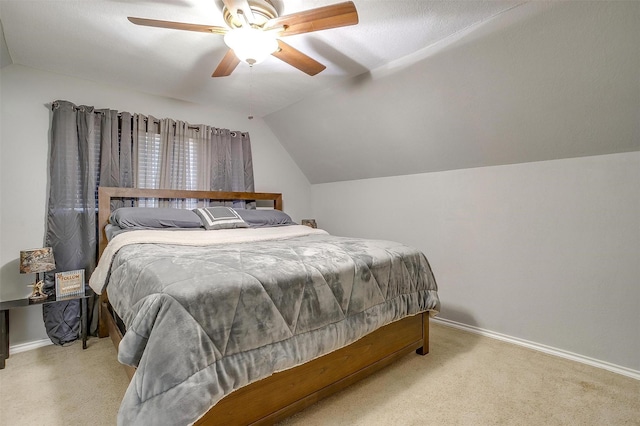 bedroom featuring carpet flooring, ceiling fan, baseboards, and vaulted ceiling