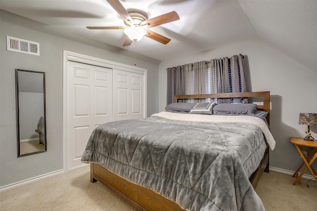 bedroom featuring lofted ceiling, a closet, visible vents, and carpet floors