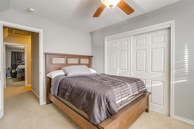 bedroom with ceiling fan, baseboards, a closet, and light carpet